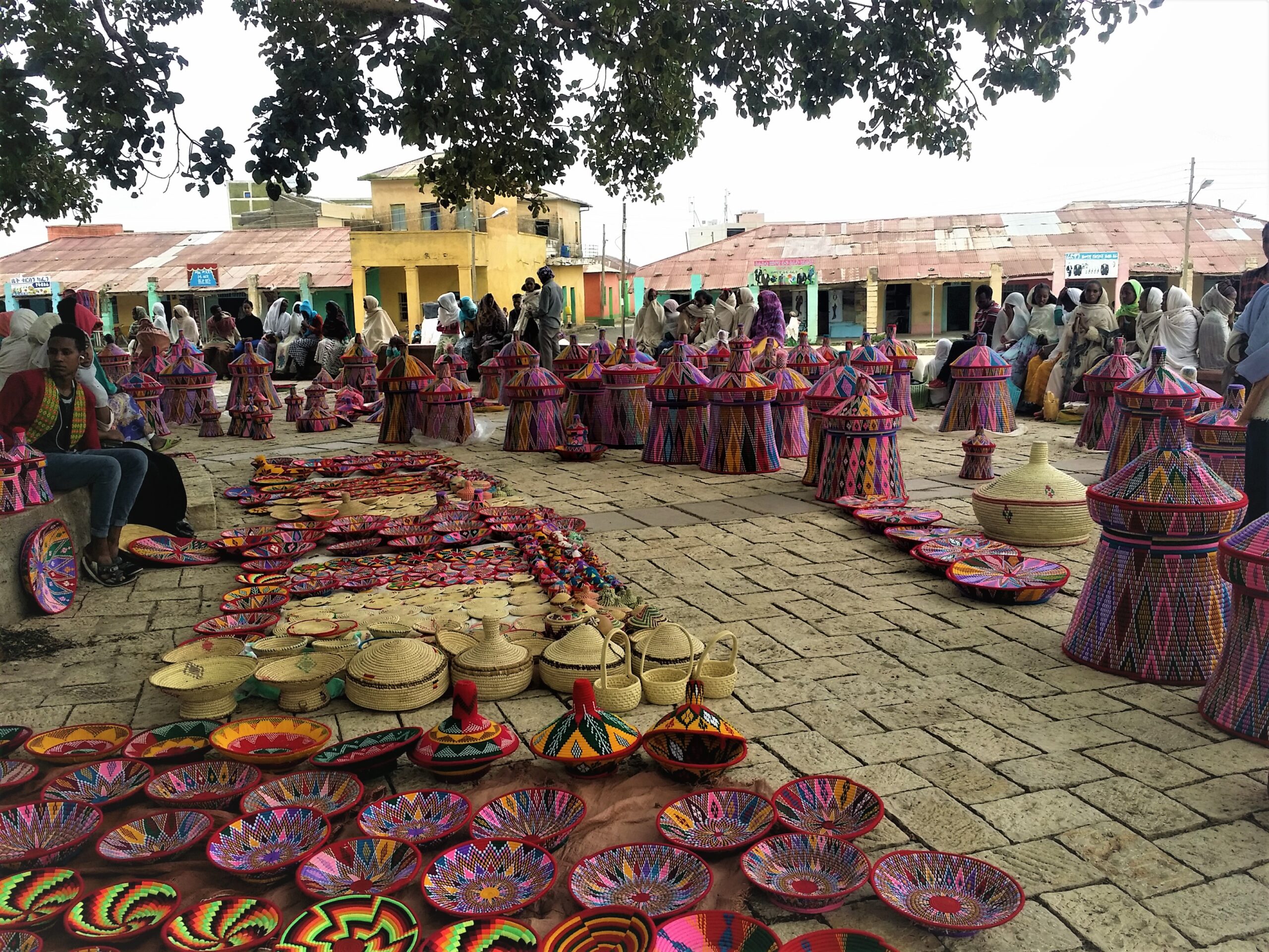 Ethiopian milk baskets along an outdoor walkway