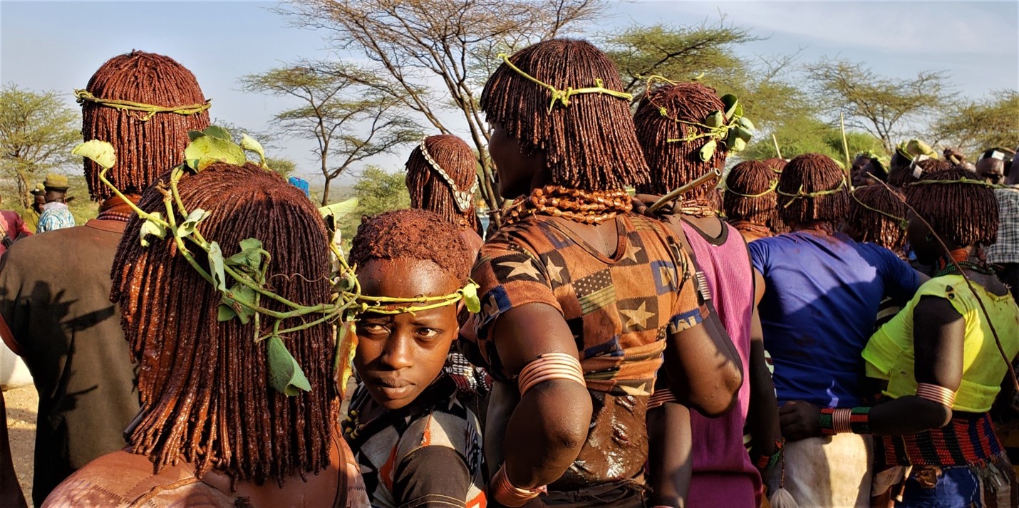 African individuals wearing traditional cultural attire and headwear