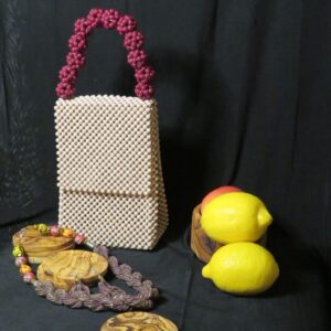 Small beaded cream colored purse with a necklace