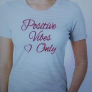 White tee shirt that reads, "Positive vibes only" in pink writing and a pink heart next to it